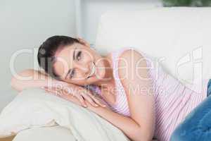 Smiling and relaxing woman lying on a couch