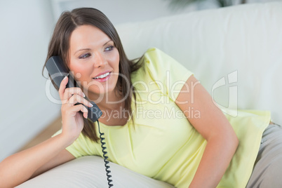 Woman sitting and calling in the living room