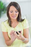 smiling woman touching her smartphone