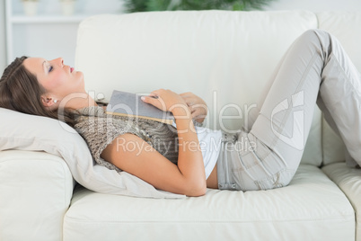 Woman lying on sofa and sleeping deeply