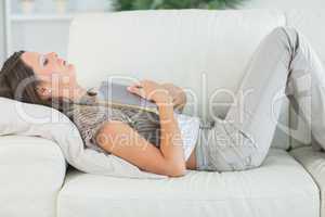 Woman lying on sofa and sleeping deeply