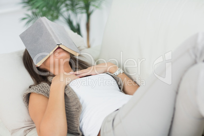 Woman sleeping with her book on the head