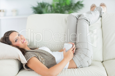 Calm woman lying on the sofa