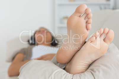 Woman with her feet up listening to music