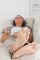 Woman listening to music with her feet up