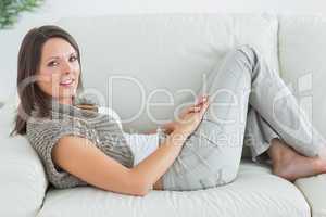 Happy woman relaxing on sofa