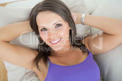 Happy woman lying on sofa