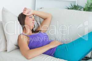 Anxious woman lying on sofa