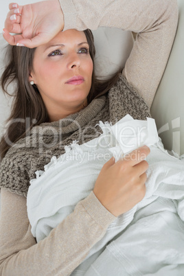 Ill woman lying on sofa