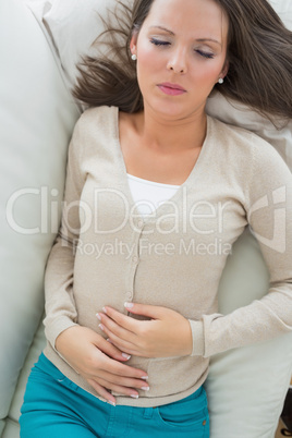 Sick woman lying on the sofa and sleeping