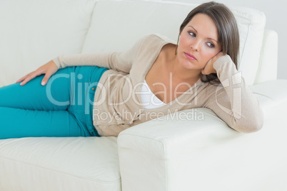 Upset woman lying on couch