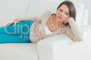 Upset woman lying on couch