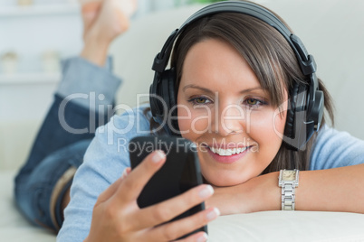 Woman using her smartphone and listening to music