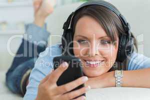 Woman using her smartphone and listening to music