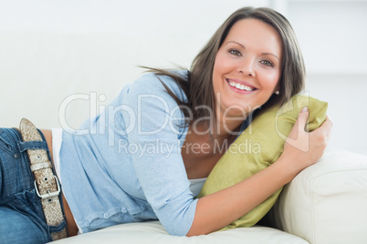 Laughing woman lying on sofa