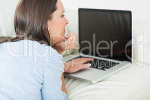 Woman typing on her laptop