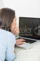 Brunette woman typing on the laptop