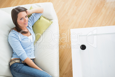 Bruenette woman lying on sofa