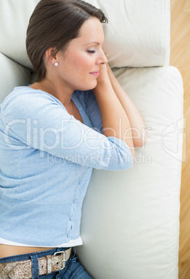 Woman lying and sleeping on sofa