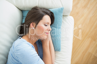 Calm woman lying and sleeping on sofa