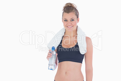 Woman smiling while holding a bottle of water Woman smiling while holding a bottle of water