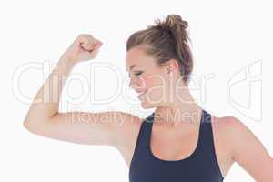 Woman standing showing her muscles