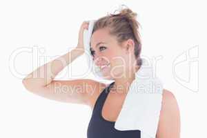 Woman smiling while holding towel at her forehead