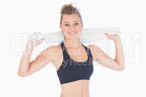 Woman standing while holding towel after workout