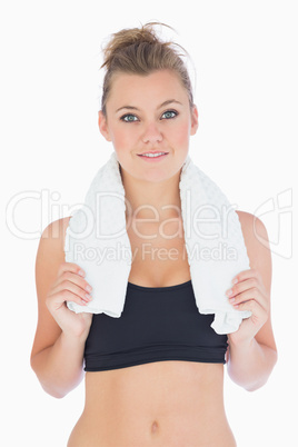 Woman standing while holding a white towel in sportswear