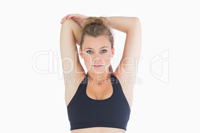 Woman standing stretching her arms