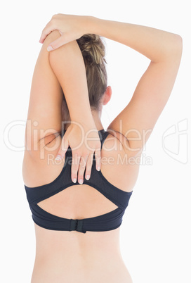 Woman stretching arms over back