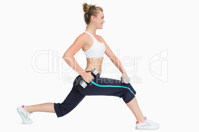 Woman stretching while holding weights