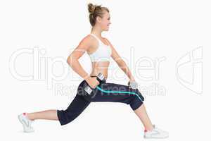 Woman stretching while holding weights