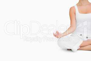 Woman doing yoga while cross-legged