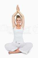 Girl sitting in lotus yoga pose