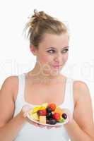 Woman holding a plate of fruit