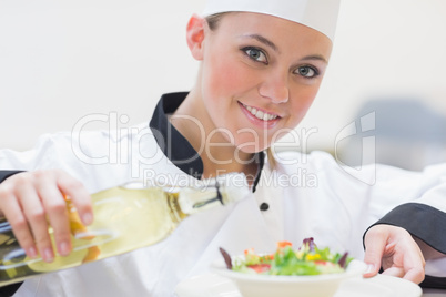 Smiling chef preparing a salad