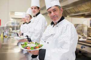 Cheerful Chef's showing their salads