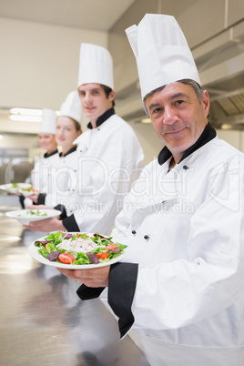 Smiling Chef's presenting their salads