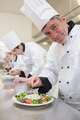 Cheerful Chef's preparing their salads