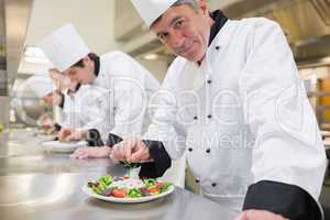 Smiling Chef's preparing their salads