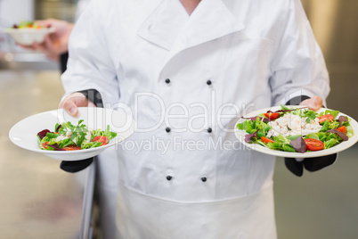 Chef holding two salads