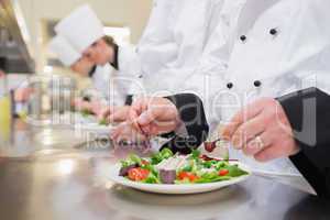 Chef garnishing salads