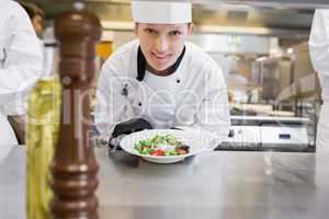 Happy chef presenting her salad