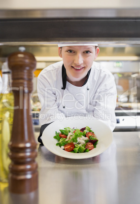 Chef happily presenting salad