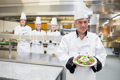 Head chef presenting salad