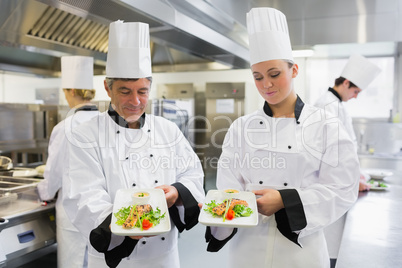 Two Chef's presenting their salmon dishes