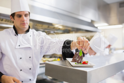 Chef garnishing his cake