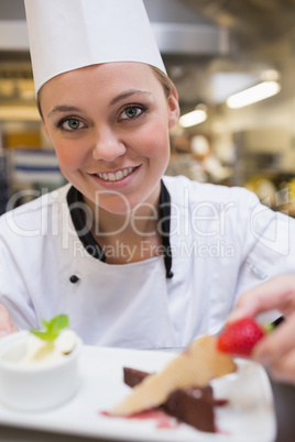 Happy chef garnishing a slice of cake