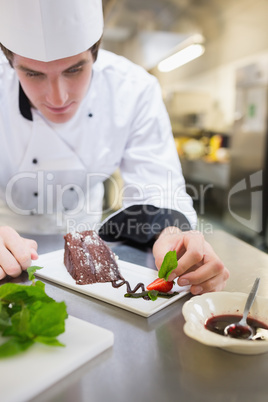 Chef putting mint on the desert plate